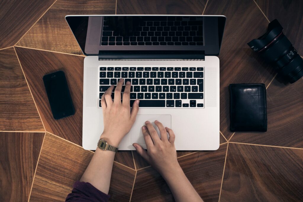 Oberhead shot of a woman's hands on an Apple laptop computer