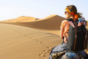 Woman riding in the Sahara