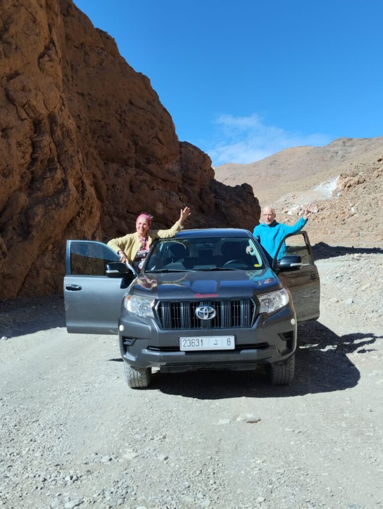 Two people in a 4x4 with doors open in Morocco