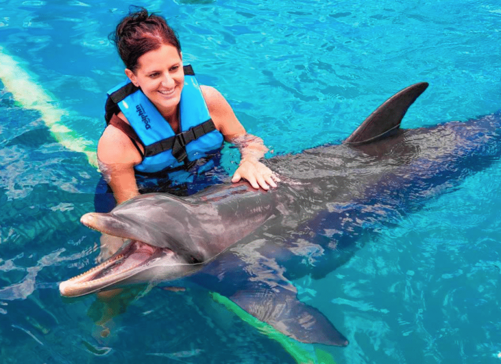 Woman swimming with a dolphin
